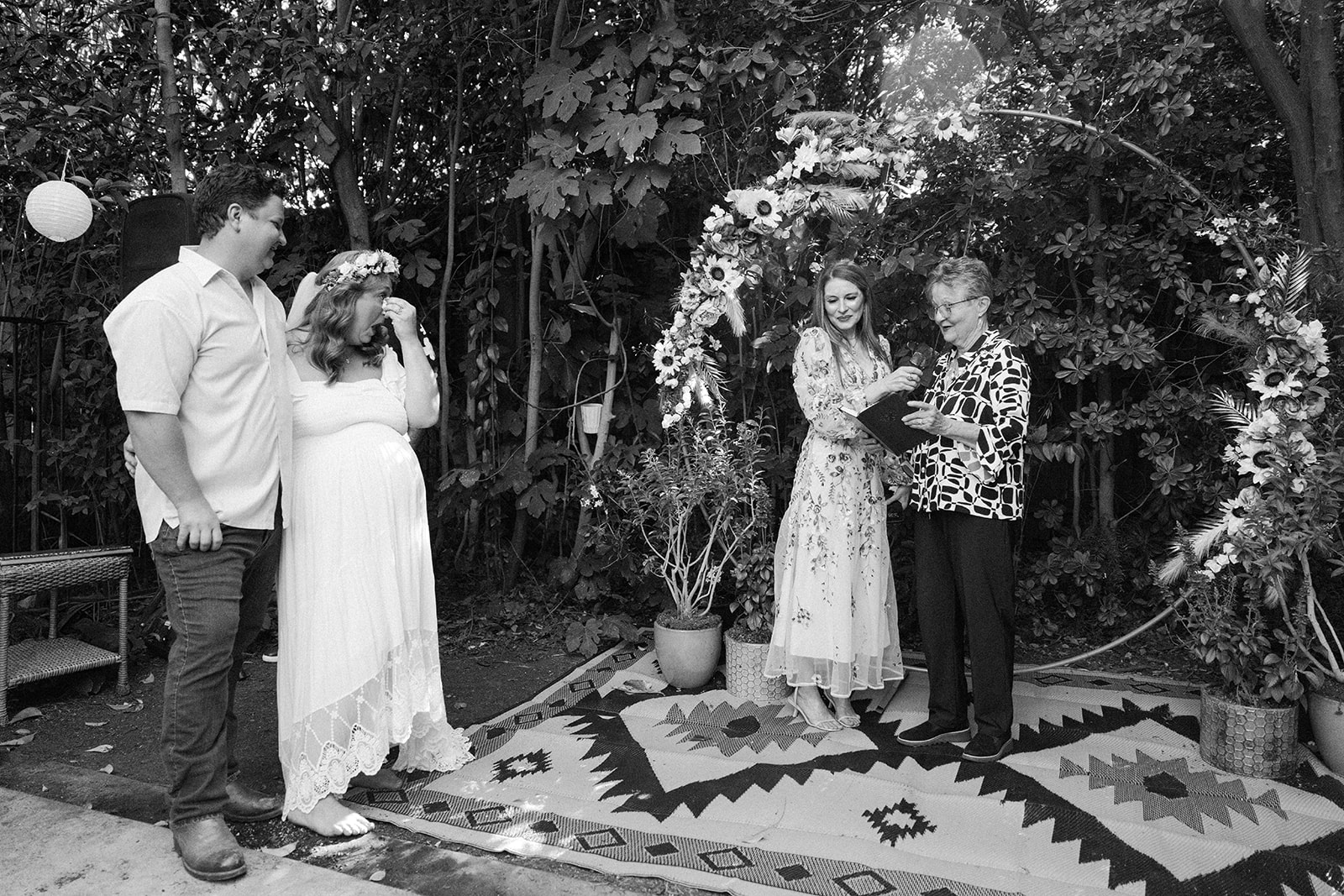 the bride and groom tearing up as someone says a speech
