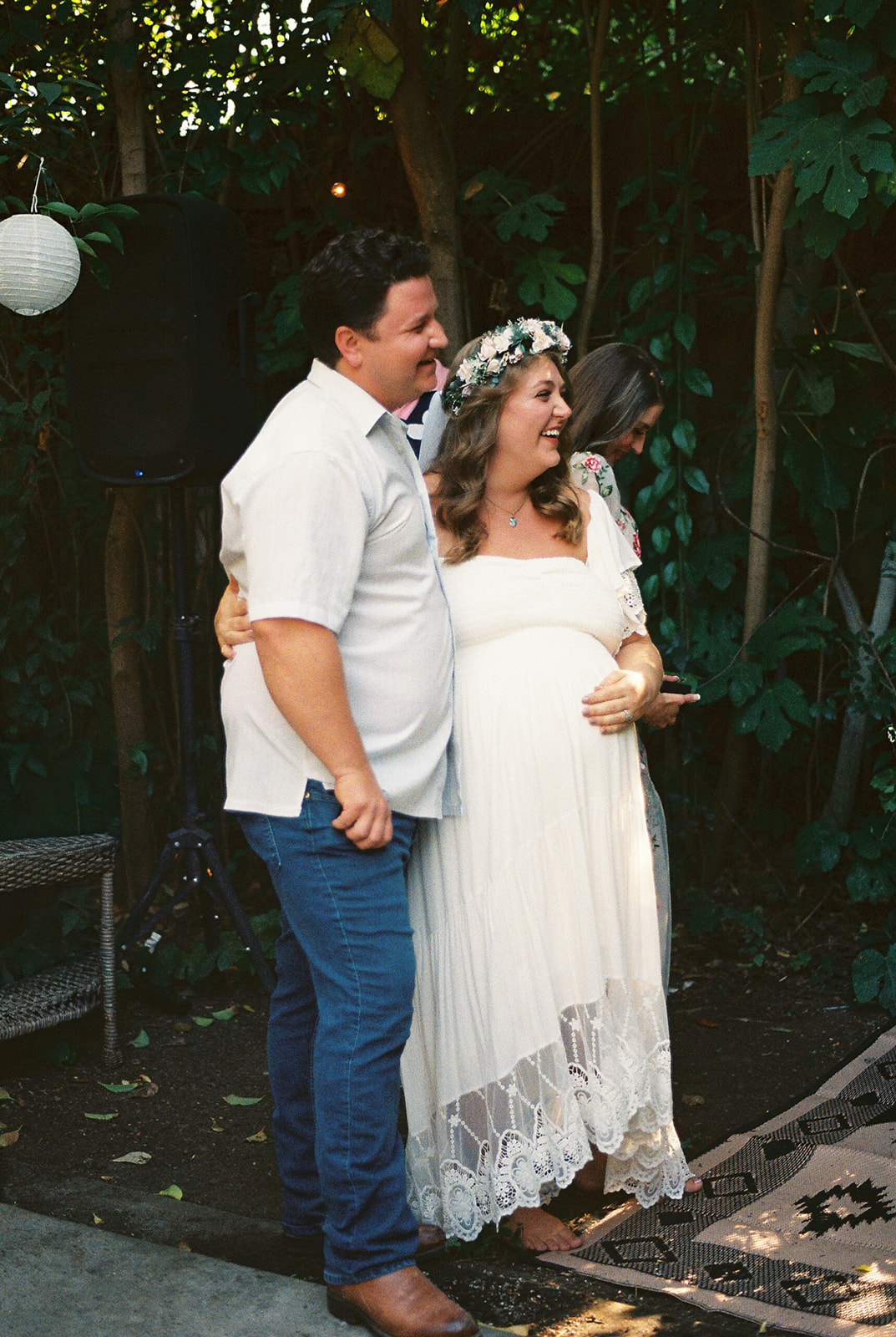 bride and groom listening to speeches and smiling 