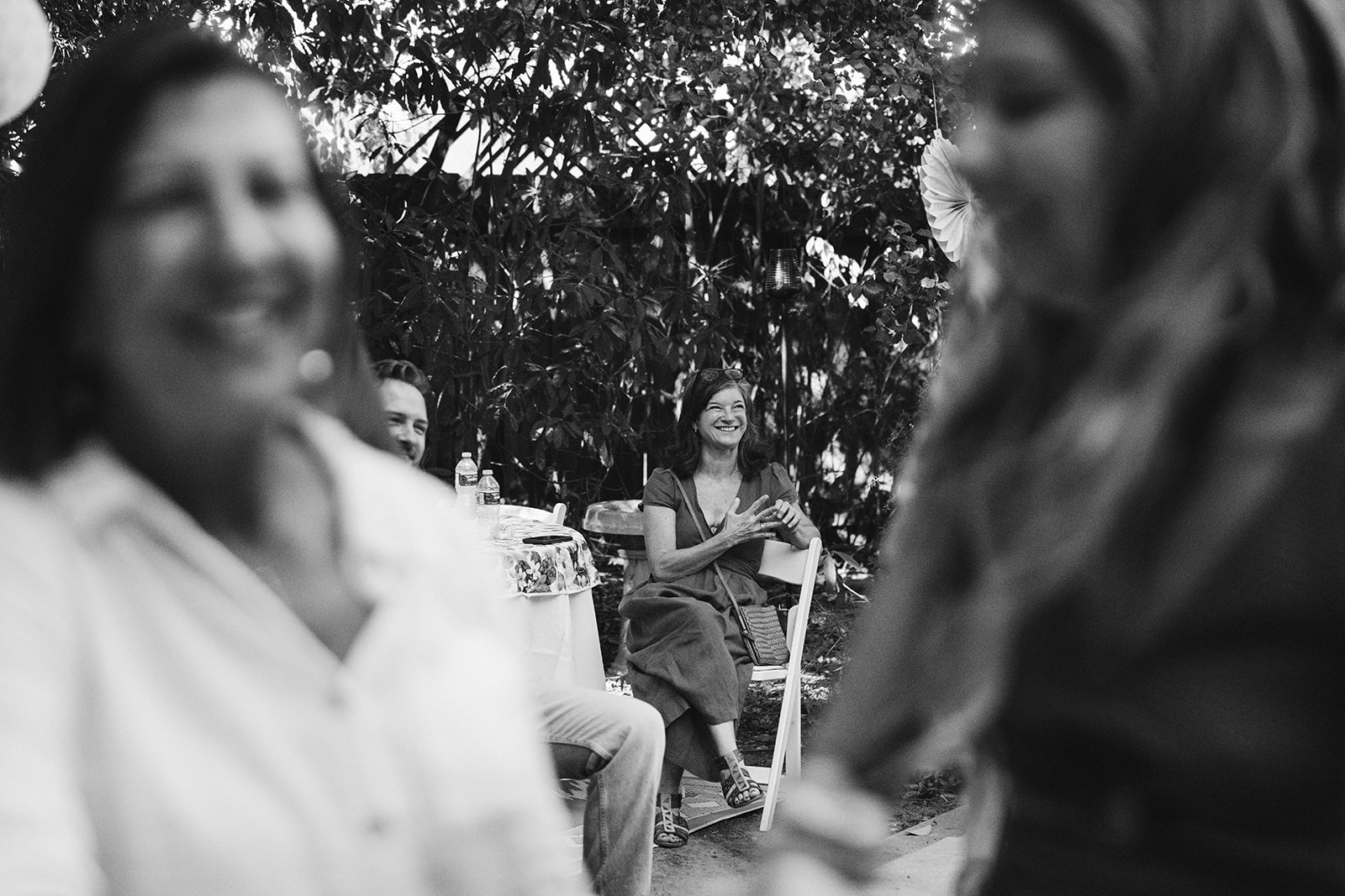 a wedding guest smiling as she listens to the speech 