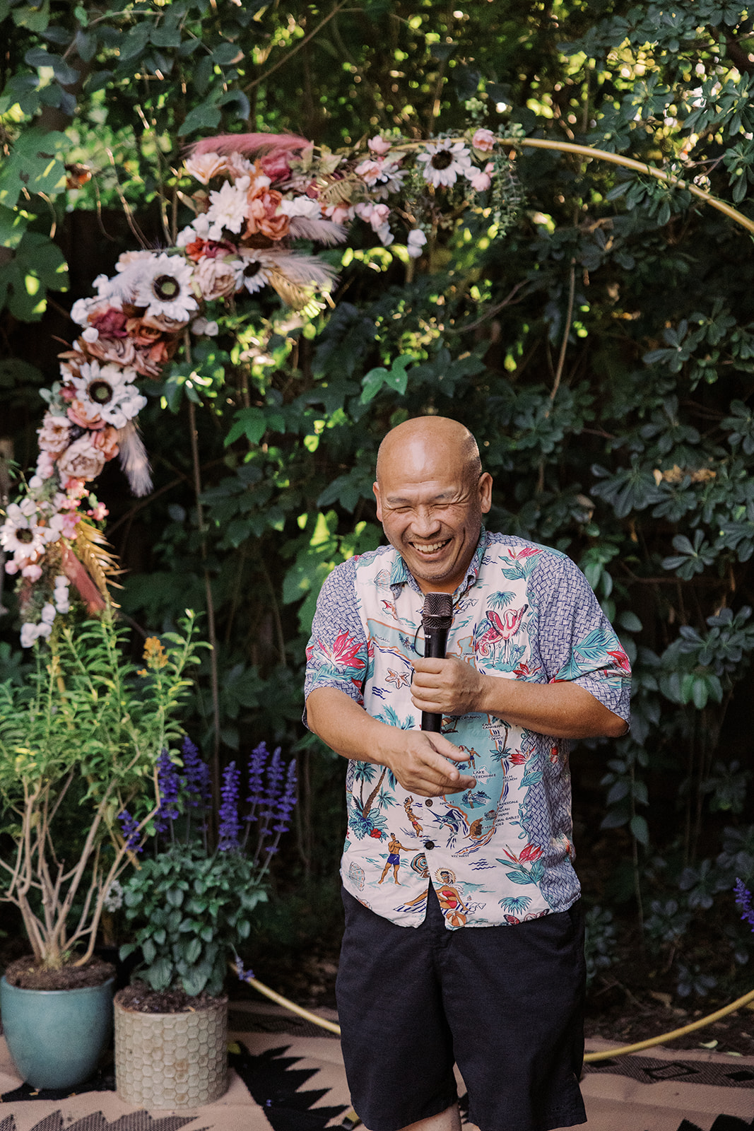 a guest laughing as he gives a speech during the Small Intimate Wedding