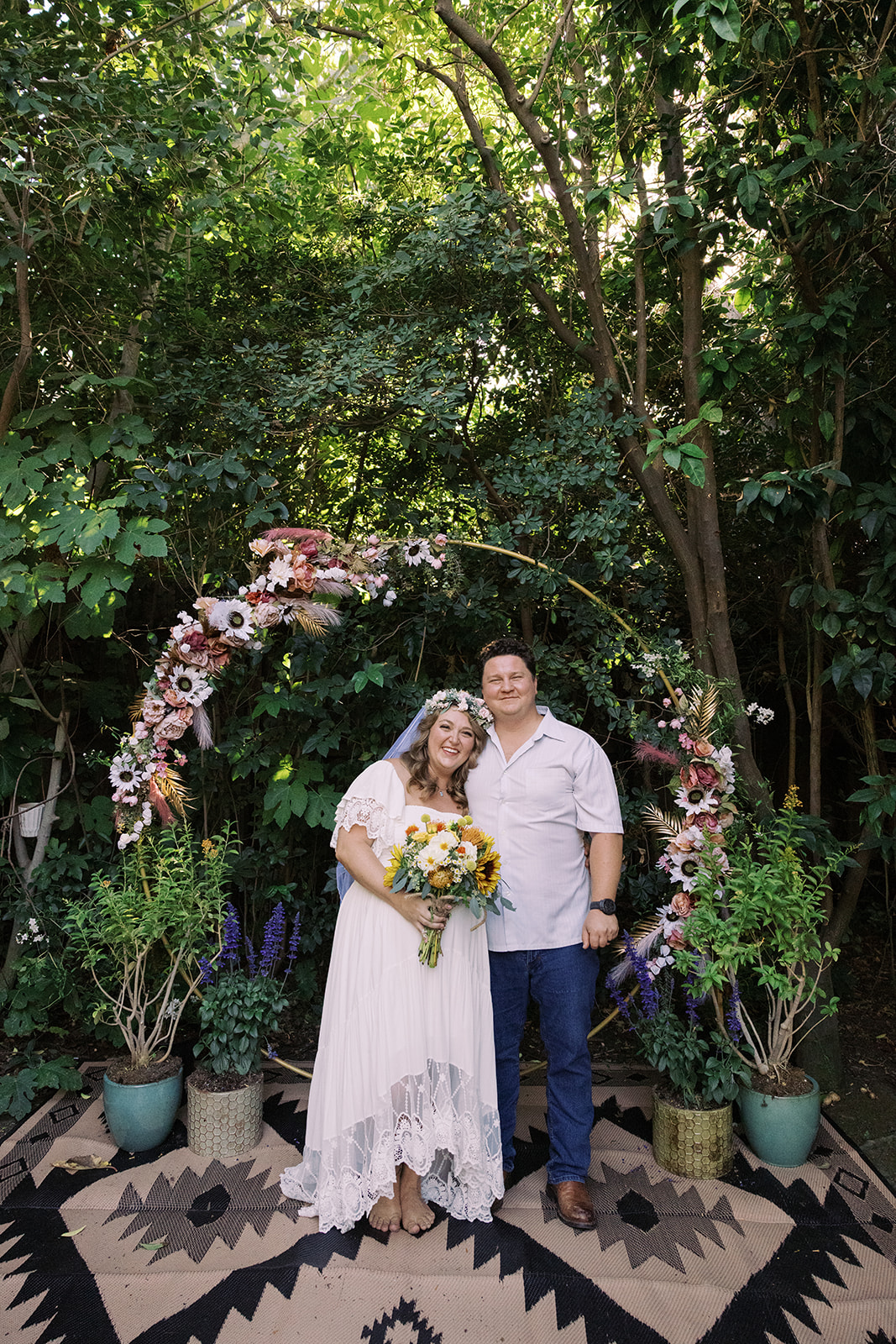 the bride and groom smiling at their altar 