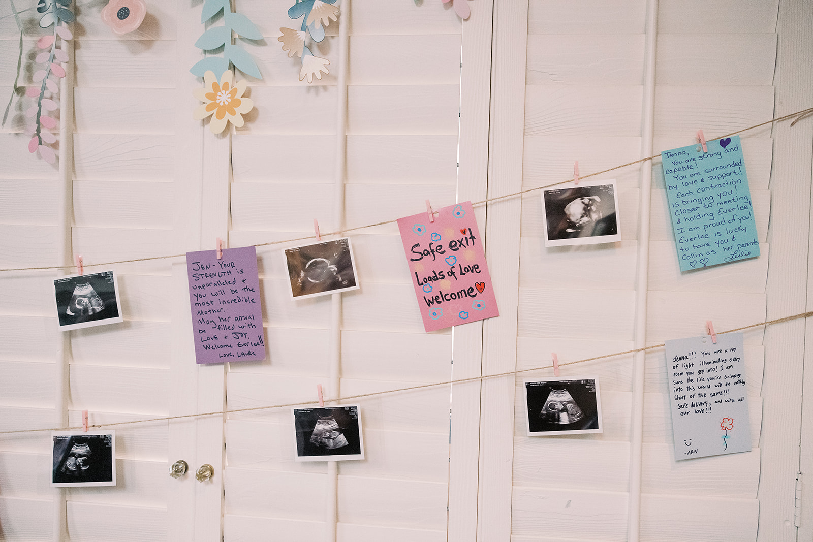 notes and sonogram images hanging on the wall 