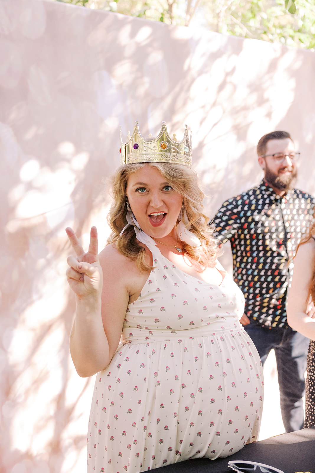 bride to be wearing a crown and she gives a piece sign 