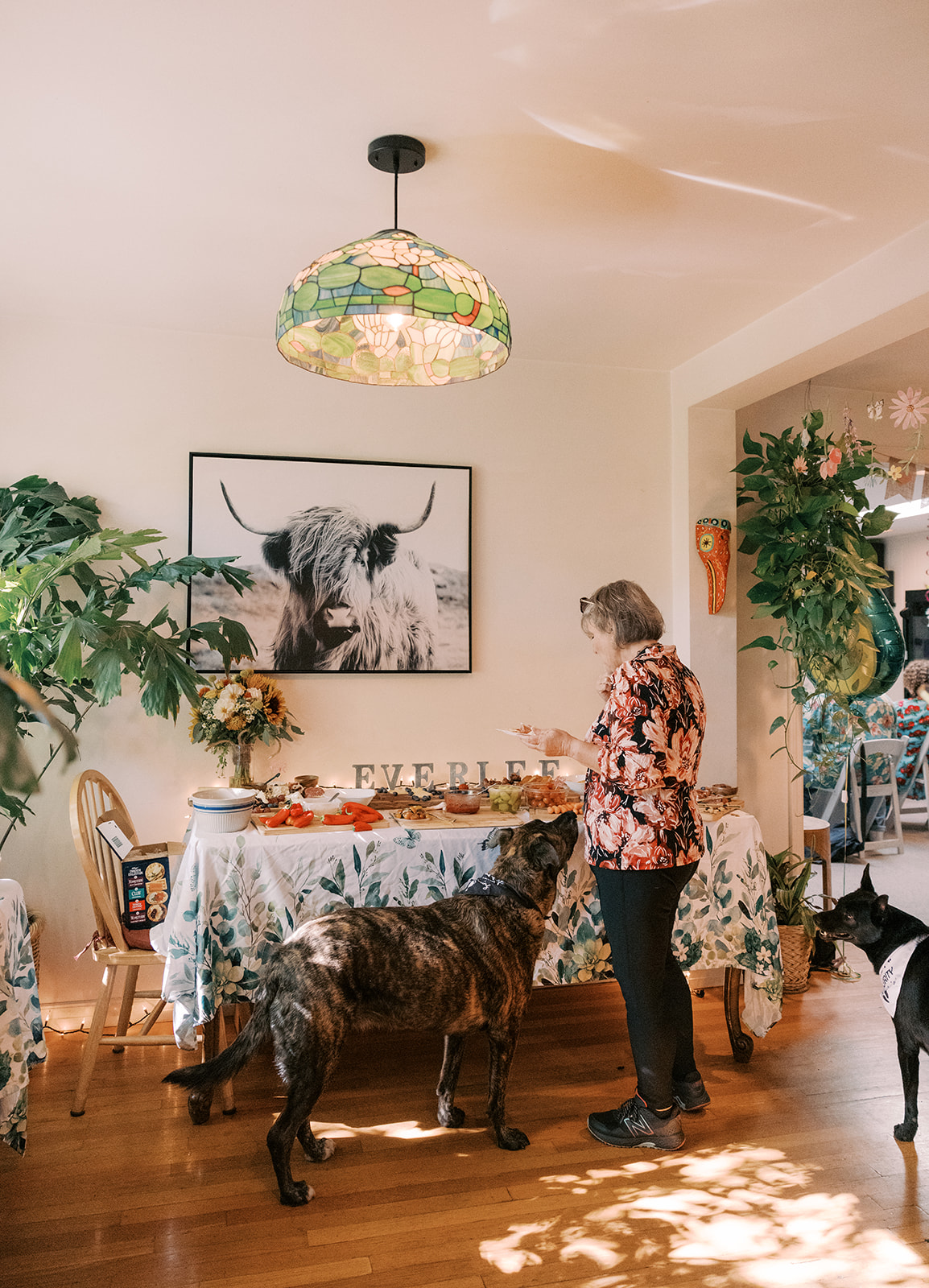 a guest standing with a dog at the food table for the surprise Small Intimate Wedding