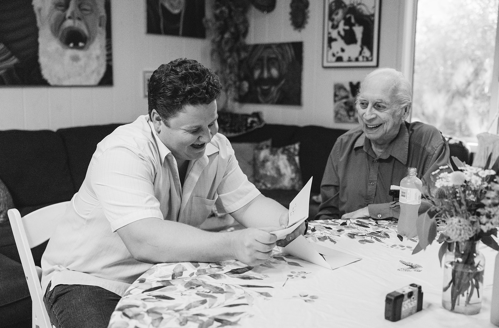 the groom to be laughing with a family member 