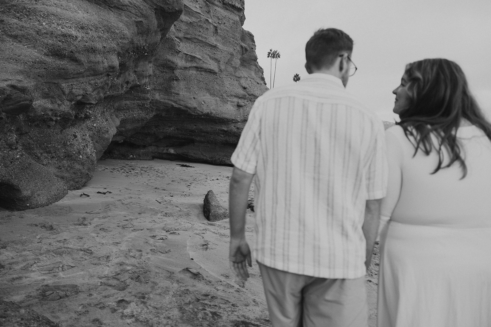 a couple walking on the beach together at Laguna Beach 