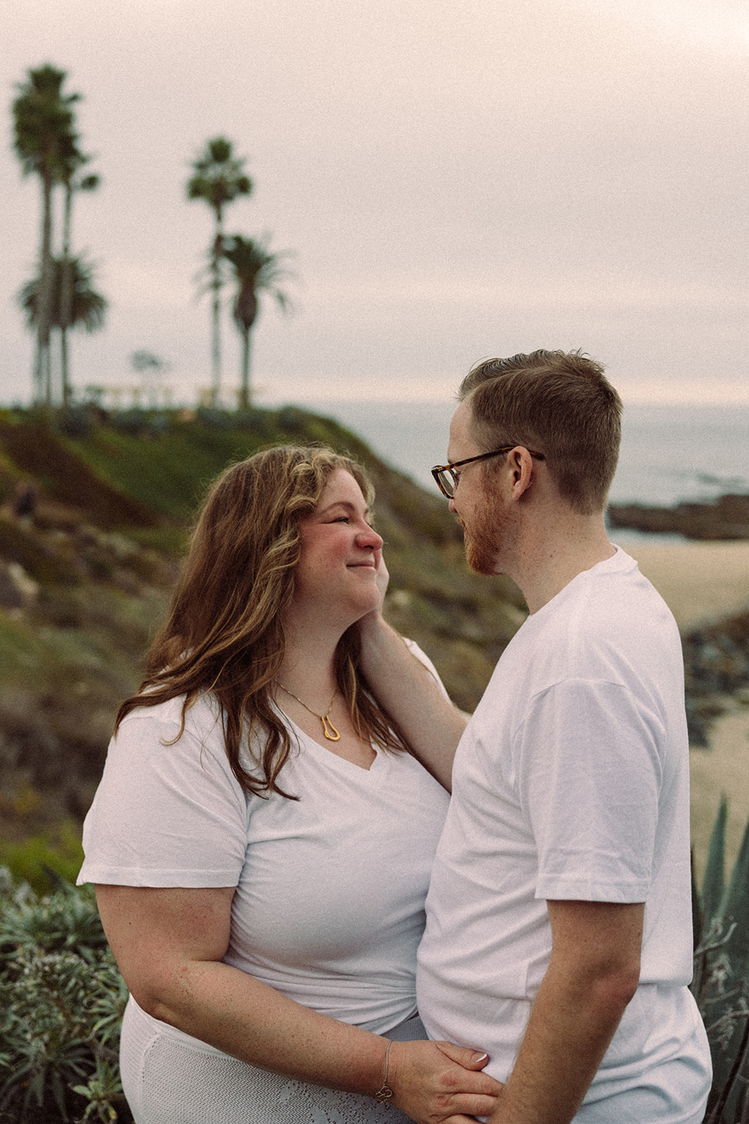 a loving couple looking into each other's eyes at the beach in California 